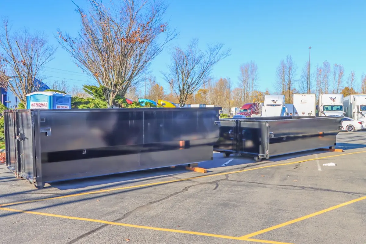 Professional dumpster rental service with roll-off container on residential driveway in Oakton